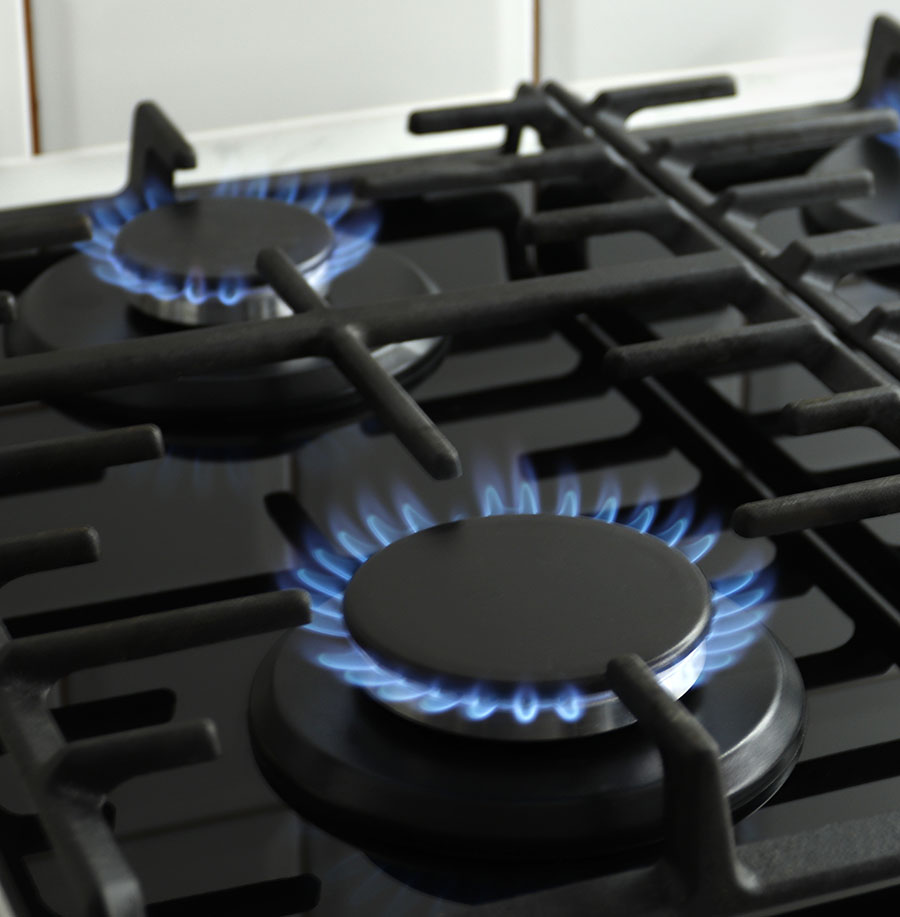 Closeup shot of blue fire from stove top