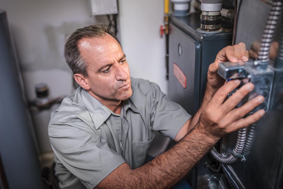 Technician Inspecting Furnace