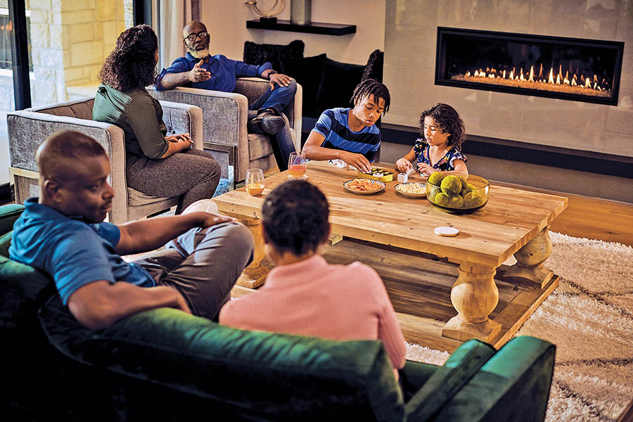 family enjoying propane fireplace