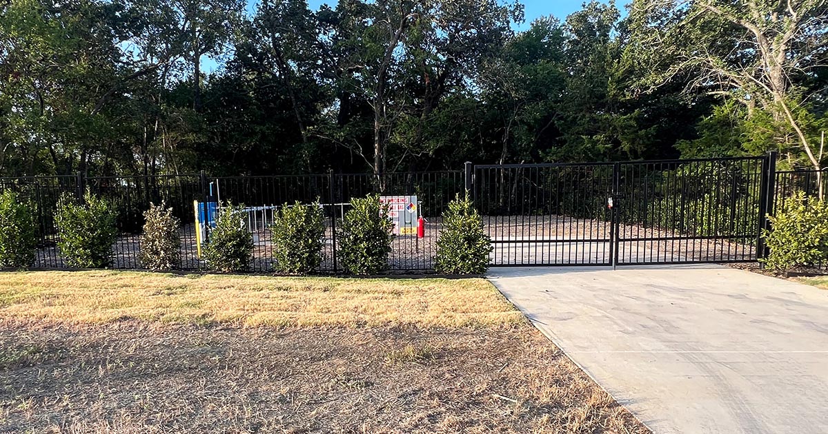 Community propane system behind fence and bushes